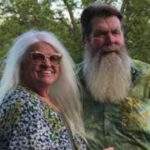 Ron and Caryl McAdoo. She has long loose platinum hair, he has brown hair and a long gray beard.